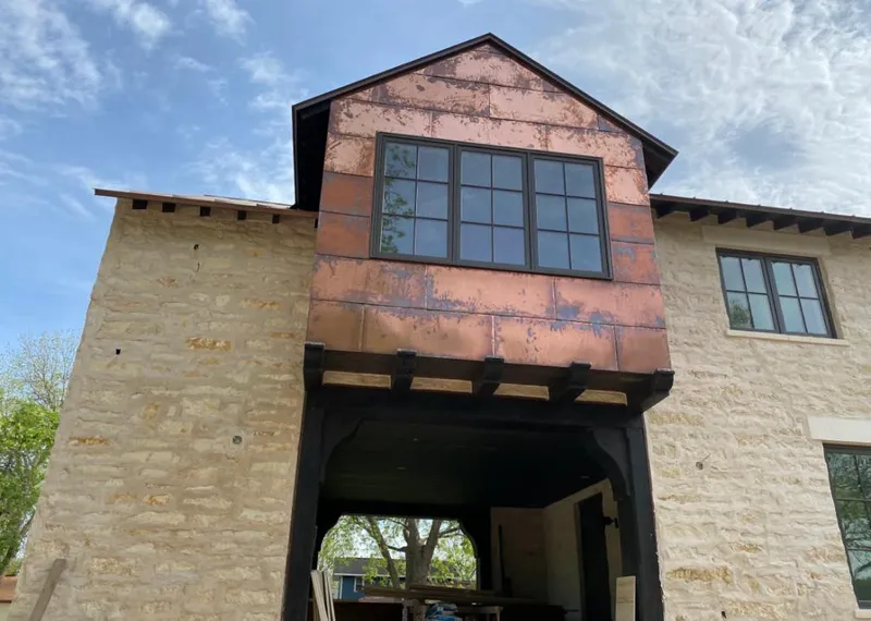 Copper metal panel facade on a stone building for Skylight Installation in Bullard